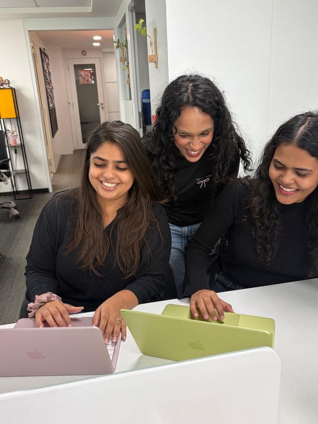 Team members working together on a laptop